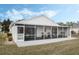 White house with large screened patio at 524 Lake Suzanne Dr, Lake Wales, FL 33859