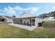 White house with screened patio and grassy backyard at 524 Lake Suzanne Dr, Lake Wales, FL 33859