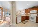 Kitchen with wooden cabinets, white appliances, and breakfast bar at 524 Lake Suzanne Dr, Lake Wales, FL 33859