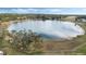 Peaceful lake view with a large oak tree and grassy area at 524 Lake Suzanne Dr, Lake Wales, FL 33859