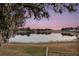 Scenic lake view with serene sunset reflections at 524 Lake Suzanne Dr, Lake Wales, FL 33859