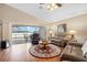 Living area with hardwood floors, leather furniture, and sliding glass doors at 524 Lake Suzanne Dr, Lake Wales, FL 33859