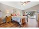 Main bedroom with a king-size bed, wood flooring, and access to a patio at 524 Lake Suzanne Dr, Lake Wales, FL 33859