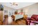 Main bedroom with king-size bed, wood floors, and a relaxing seating area at 524 Lake Suzanne Dr, Lake Wales, FL 33859