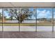 Screened porch overlooking a tranquil lake view at 524 Lake Suzanne Dr, Lake Wales, FL 33859
