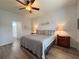 Main bedroom with king-size bed, wood nightstands, and ensuite bathroom at 5341 Nicklaus Dr, Winter Haven, FL 33884