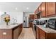 Well-equipped kitchen with wood cabinets and granite countertops at 716 Brooklet Dr, Davenport, FL 33837