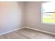 Bright bedroom features wood-look flooring and a window with a pleasant view at 746 Platypus Ct, Kissimmee, FL 34759