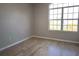 Bedroom featuring wood-look flooring and a large window with a street view at 746 Platypus Ct, Kissimmee, FL 34759