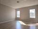 Bedroom featuring wood-look flooring and dual windows providing natural light at 746 Platypus Ct, Kissimmee, FL 34759