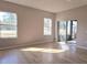 Bedroom with wood-look flooring, ample natural light, and access to an enclosed patio at 746 Platypus Ct, Kissimmee, FL 34759