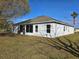 Rear exterior view showcases the screened in porch and mature landscaping at 746 Platypus Ct, Kissimmee, FL 34759
