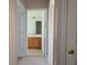 Hallway view of full bathroom with brown vanity at 746 Platypus Ct, Kissimmee, FL 34759