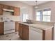 Kitchen with white appliances and an island sink, complete with ample counter space at 746 Platypus Ct, Kissimmee, FL 34759