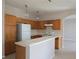 Spacious kitchen with ample wood cabinetry, breakfast bar, and white appliances at 746 Platypus Ct, Kissimmee, FL 34759