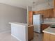 The kitchen features wooden cabinetry and a breakfast bar, perfect for casual dining at 746 Platypus Ct, Kissimmee, FL 34759