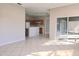 Open-concept living space featuring tile flooring, bright natural light, and access to an enclosed patio at 746 Platypus Ct, Kissimmee, FL 34759