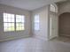 Bright living room with tile floors, large windows, neutral paint, and plenty of natural light at 746 Platypus Ct, Kissimmee, FL 34759