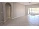 Bright living room has neutral paint and tile floors, with a glass sliding door and side window at 746 Platypus Ct, Kissimmee, FL 34759