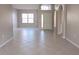 Inviting living room featuring neutral walls, tile floors, natural light, and open access to the home at 746 Platypus Ct, Kissimmee, FL 34759