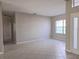 Spacious living room features tile flooring, natural light, and neutral paint to easily customize at 746 Platypus Ct, Kissimmee, FL 34759