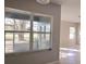 Sunroom windows offer a view of the yard outside and let in light, illuminating the tile flooring at 746 Platypus Ct, Kissimmee, FL 34759