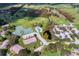 Aerial view of the community with pool, tennis courts, parking, residential homes, and landscaping at 768 Canberra Rd, Winter Haven, FL 33884