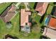 Aerial view of a home with a tile roof, screened pool, and lush landscaping at 768 Canberra Rd, Winter Haven, FL 33884