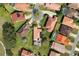 Aerial view of lush green lawns, pools, and homes with beautiful red tile roofs at 768 Canberra Rd, Winter Haven, FL 33884