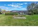 Landscaped backyard with a screened-in pool and a small rock garden at 768 Canberra Rd, Winter Haven, FL 33884