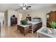 Comfortable bedroom with wood floors, ceiling fan, and classic furnishings at 768 Canberra Rd, Winter Haven, FL 33884