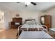 A well-lit bedroom features an ornate metal bed frame and bench, complemented by wood flooring and antique furnishings at 768 Canberra Rd, Winter Haven, FL 33884