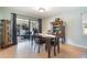Inviting dining area with wood table and chairs, opening to an enclosed patio and natural light at 768 Canberra Rd, Winter Haven, FL 33884