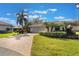 Charming home with a brick paved driveway, tile roof, and lush front yard landscaping at 768 Canberra Rd, Winter Haven, FL 33884