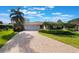 Charming single Gathering home featuring a paver driveway and mature landscaping at 768 Canberra Rd, Winter Haven, FL 33884