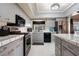 Well-lit kitchen with stainless appliances, tile countertops, and gray cabinets at 768 Canberra Rd, Winter Haven, FL 33884