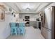Open kitchen featuring stainless steel appliances, light gray cabinets, tile countertops, and a tray ceiling at 768 Canberra Rd, Winter Haven, FL 33884