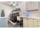 Well-equipped laundry room with modern washer and dryer, sink, and ample storage space, making laundry a breeze at 768 Canberra Rd, Winter Haven, FL 33884