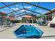 Inviting outdoor living space featuring a screened-in pool and a dining area at 768 Canberra Rd, Winter Haven, FL 33884