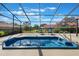 Inviting outdoor living area with a screened-in spa and lounge chairs at 768 Canberra Rd, Winter Haven, FL 33884