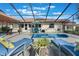 Backyard with outdoor living space featuring a screened-in spa, dining, and lounge furniture at 768 Canberra Rd, Winter Haven, FL 33884