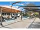 This screened-in patio area features comfortable seating and plenty of space for outdoor dining and entertaining at 768 Canberra Rd, Winter Haven, FL 33884