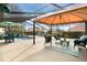 Spacious screened-in patio area with ample seating and outdoor dining options at 768 Canberra Rd, Winter Haven, FL 33884