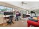 Bright sun room featuring large windows, workspace, comfortable seating and exercise equipment at 768 Canberra Rd, Winter Haven, FL 33884