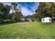 Large backyard with grassy lawn and storage shed at 811 Bonnie Dr, Lakeland, FL 33803