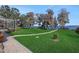 Landscaped backyard with a path leading to the lake at 8323 W Lake Marion Rd, Haines City, FL 33844
