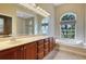 Double vanity bathroom with soaking tub and walk-in shower at 8323 W Lake Marion Rd, Haines City, FL 33844