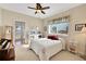 Bedroom with a queen bed, water view, and access to the outdoors at 8323 W Lake Marion Rd, Haines City, FL 33844