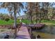 Wooden walkway leads to a private lakefront dock at 8323 W Lake Marion Rd, Haines City, FL 33844