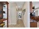 A hallway with tile floors, showing access to a bedroom and kitchen at 8323 W Lake Marion Rd, Haines City, FL 33844